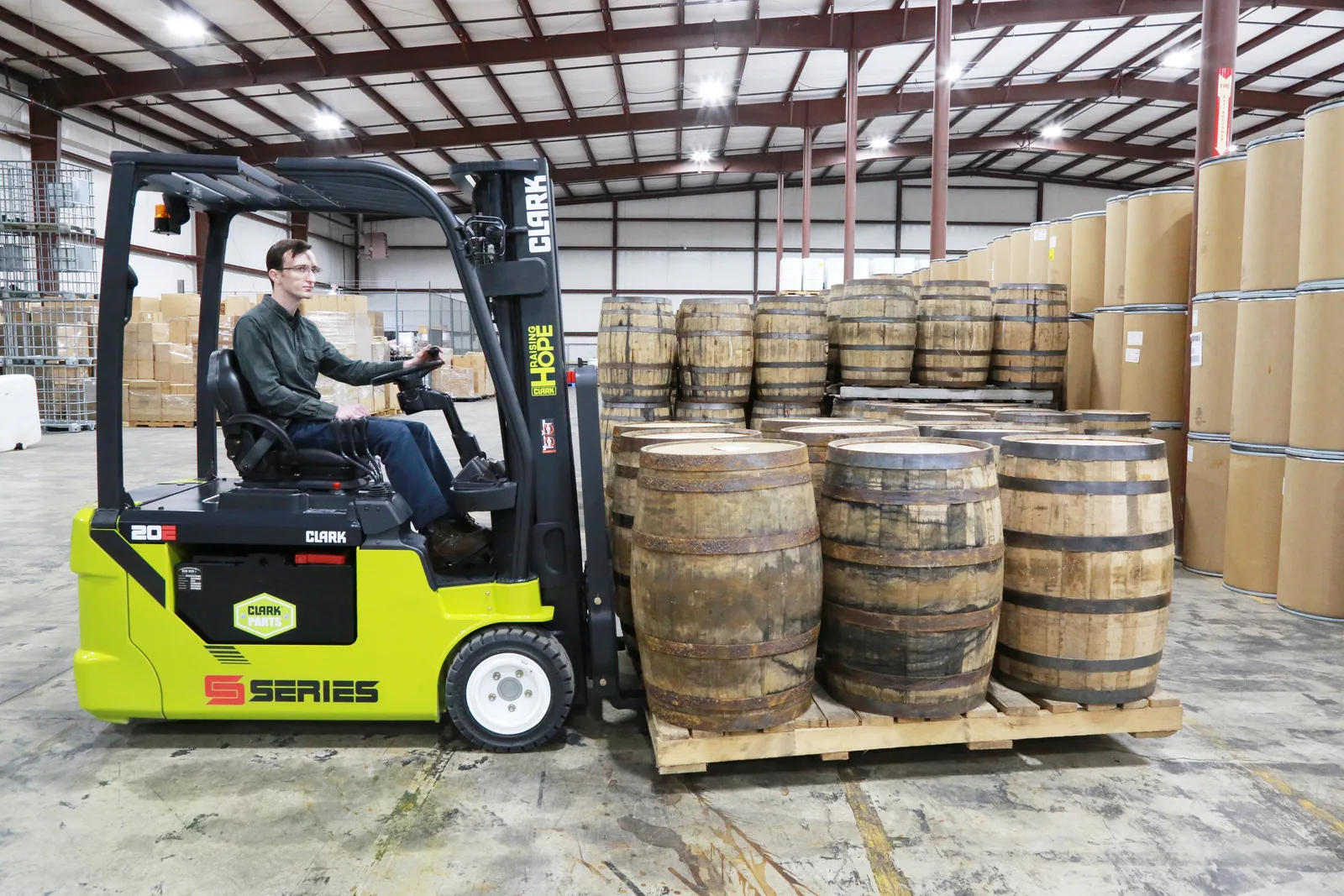 Clark S-Series electric forklift moving barrels in a Lehigh Valley warehouse