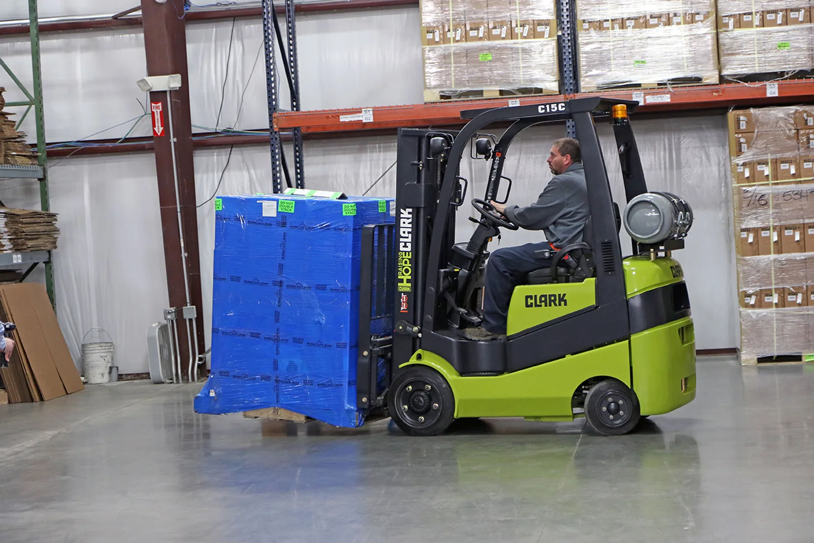 Clark C15C forklift carrying a wrapped pallet past pallet racking in a Lehigh Valley warehouse