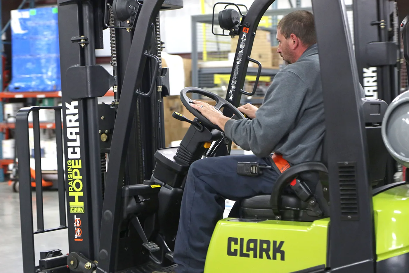 Operator at the controls of a Clark C15C forklift in a Lehigh Valley warehouse